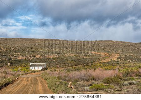 Matjiesrivier, South Africa, August 27, 2018: Landscape With An Historic House With Reed Roof At Mat