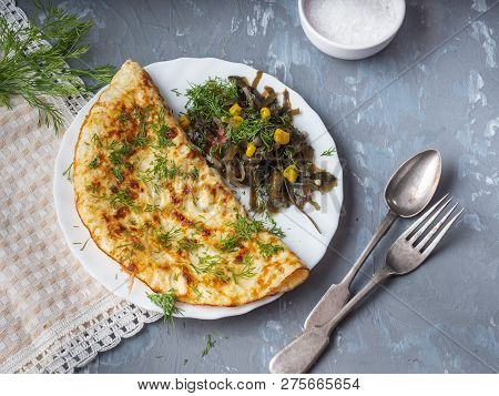 Breakfast Of Omelet, Seaweed Salad, Cotton Napkin Laid On A Plate