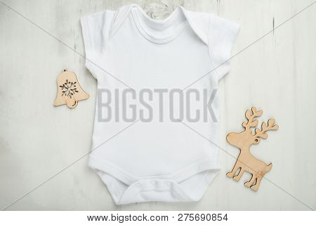 Layout Flat Lay White Baby Bodysuit Shirt, On A White Background With Children's Wooden Toys. Mock U