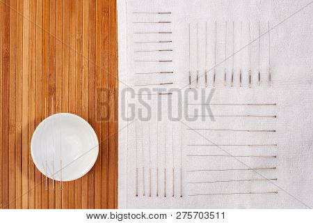 Table With Needles For Acupuncture. Silver Needles For Traditional Chinese Acupuncture Medicine On A