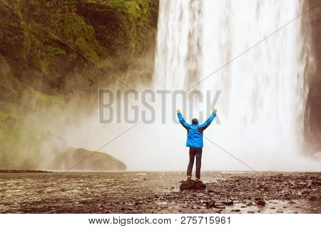 Single Man Standing Near Scogafoss Waterfall In Iceland And Spread His Hands. Travel Summer Nordic C