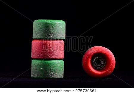 Old Vintage Consumed Skate Wheel On A Black Background