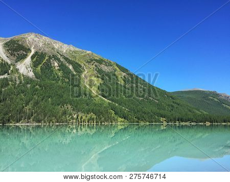 Beautiful Blue Kucherla Lake. Reflection Of Mountains In The Water. Summer Vacation In The Mountains