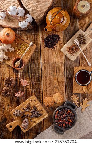 Autumn Winter Still Life. A Teapot And A Cup Of Tea On A Wooden Table With Different Goodies. The Ap