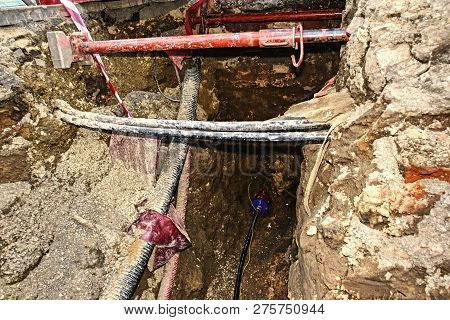 Crossection Of Metallic And Fiber Optic Cables With Potable Water Tap Threads.  Mechanized Excavatio