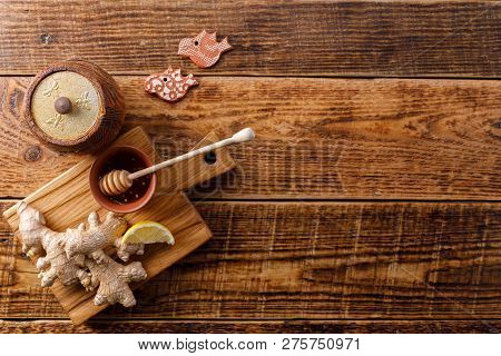 Barrel Of Honey With Ginger Root And Lemon On Wooden Background. Flat Lay. Copy Space.