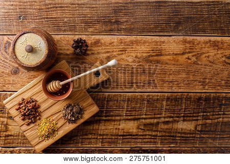Barrel Of Honey With Bee Products On A Wooden Background. Flat Lay. Copy Space.
