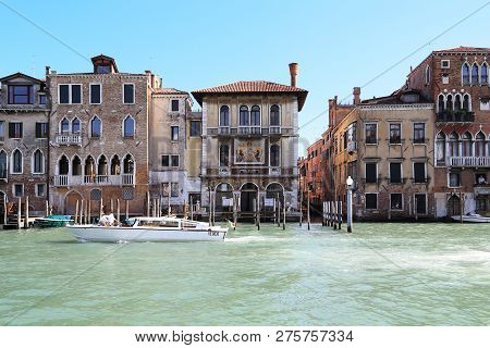 Venice, Italy - May 18, 2018: Boat Float Down The Grand Canal Past The Palazzo Barbarigo