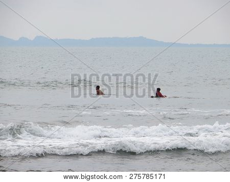 Anyer, Indonesia - June 24, 2018: Some Boys Swim On The Sea At Sambolo Beach.