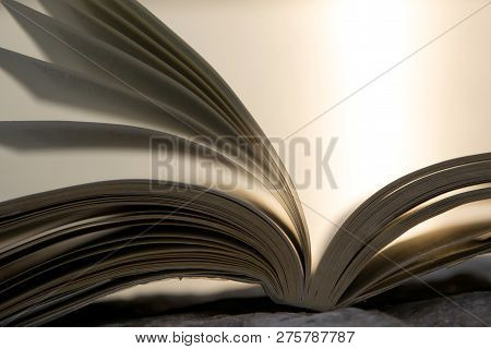 Open Book With Bright Light On Background, Space For Text