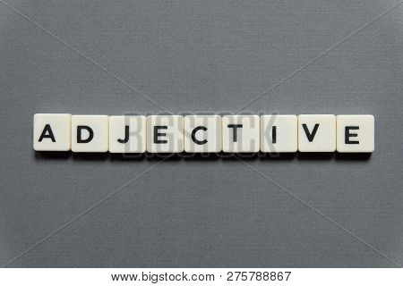 Adjective Word Made Of Square Letter Word On Grey Background.