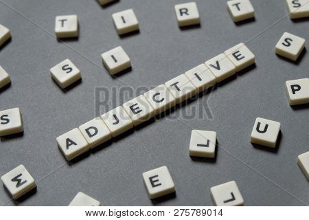Adjective Word Made Of Square Letter Word On Grey Background.