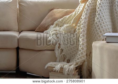 Stylish Brightly Interior Of Living Room. Inviting Comfortable Sofa With Handmade Woolen Blanket And