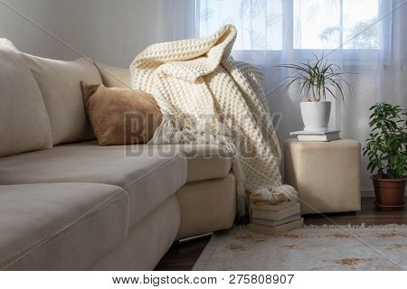 Stylish Brightly Interior Of Living Room. Inviting Comfortable Sofa With Handmade Woolen Blanket, Bo