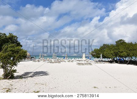 Pretty Beach With Beach Chairs And Umbrellas
