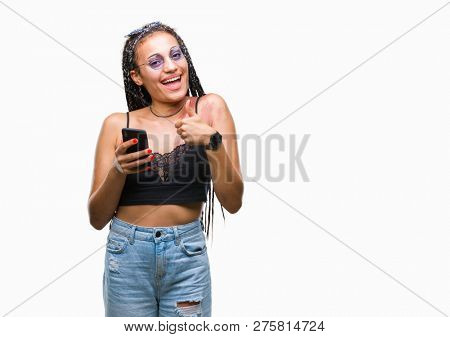 Young braided hair african american with birth mark using smartphone over isolated background happy with big smile doing ok sign, thumb up with fingers, excellent sign
