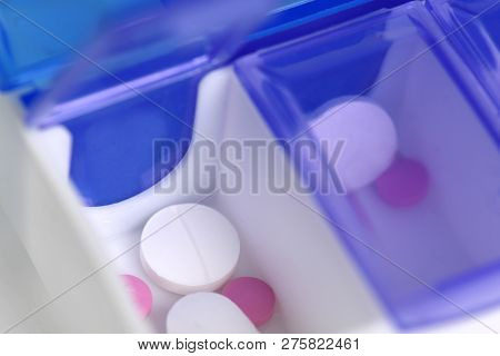Medication Shown In A Daily Pill Box Dispenser , Copy Space At Base And To The Side