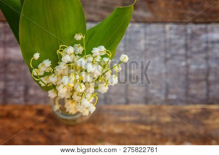 Bouquet Of Flowers Beautiful Smell Lily Of The Valley Or May-lily In Glass Vase On Rustic Old Vintag