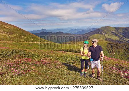 Couple - Active Hikers Hiking Enjoying View Looking At Mountain Forest Landscape In Yosemite Nationa