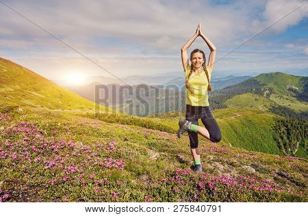 Young Fitness Woman Practice Yoga At Mountain Peak Cliff Edge