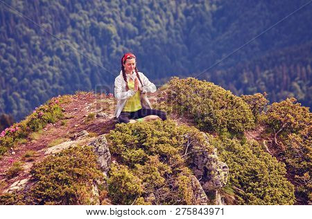 Young Fitness Woman Practice Yoga At Mountain Peak Cliff Edge