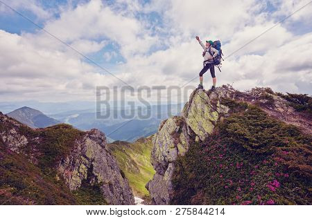 Cheering Young Woman Backpacker At Sunrise Seaside Mountain Peak