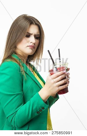 Healthy Food Eating. Choosy Thinking Woman With Both Green And Red Detox Vegetable Smoothie. Posing 