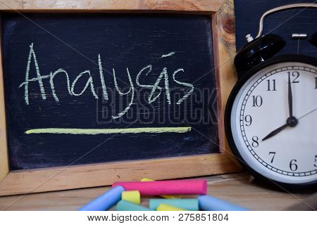 Analysis. Back To School Concept. Alarm Clock On Wooden With Blackboard On Background