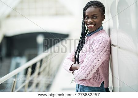 Young Beauty African Woman With Crossed Hands Standing In Office Hall