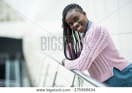 Young Pretty Afro American Woman Relaxing On Handsrails In Modern Office