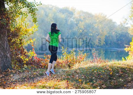 Sporty Girl Running On The Pathway In The Forest