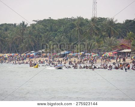 Anyer, Indonesia - June 24, 2018: Crowd Of People Doing Activities At Sambolo Beach. Month Of June I
