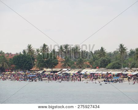 Anyer, Indonesia - June 24, 2018: Crowd Of People Doing Activities At Sambolo Beach. Month Of June I