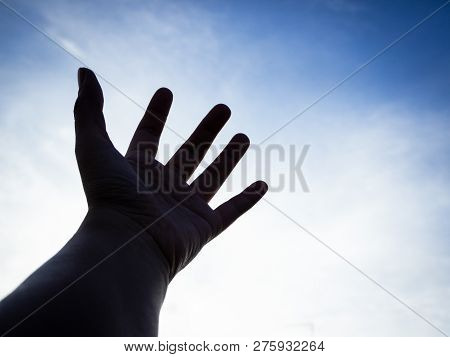 The Silhouette Humand Hand Reaching To The Sky