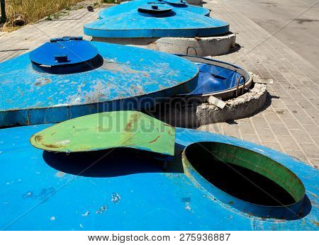 Large Stationary Trash Containers Embedded In The Ground