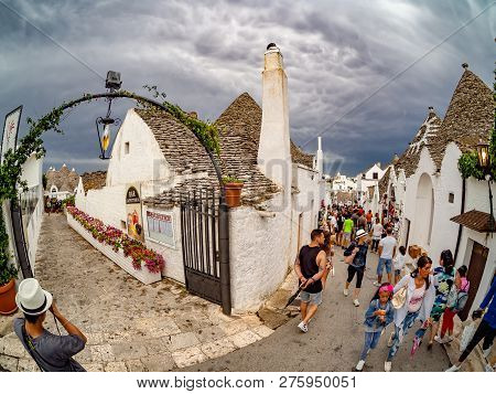 Alberobello, Apulia, Italy - August 16, 2018: Tourists Visiting The Famous Village Alberobello With 