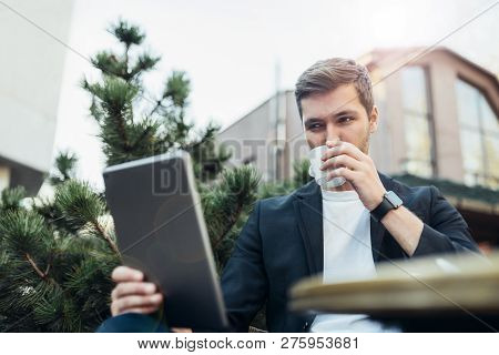 Bottom View Of Caucasian Man In Casual Suit Reading News Via The Internet Using Gagdet Device And Fr