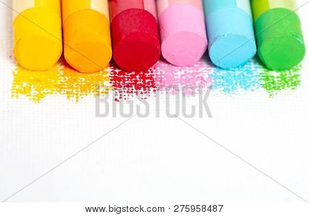 Crumbs And Chunks Of Multicolored Chalk, Oil Pestel On White Paper For Watercolor. Yellow, Pink, Red
