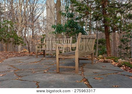 Photo Of A Pair Of Park Benches In A Park On A Cold Winter Morning.