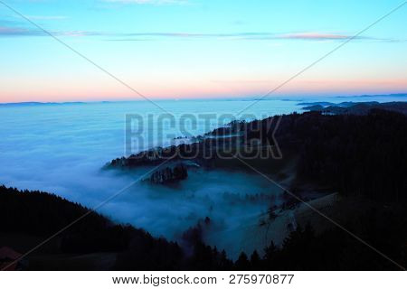 Fog Crawling Up The Hills. View From Bantiger Close To Bern At A Foggy Winterday.