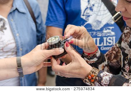Komsomolsk-on-amur, Russia - August 19, 2018. Female Volunteer Helps Older Woman Put Disposable Atta