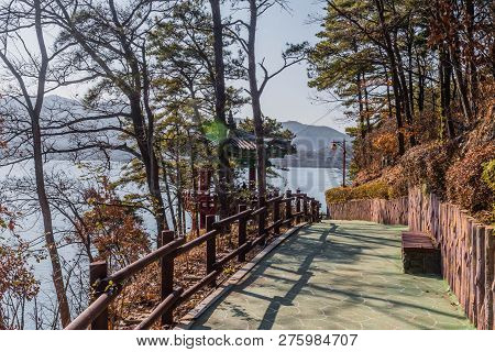 Concrete Walkway With Wooden Railing At Next To Oriental Gazebo At Yesan Lake Ecological Park In Yes