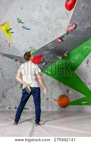 Rock Climber Man Shoved His Hands Into A Bag Of Magnesia Powder Behind His Back In The Boulder Hall