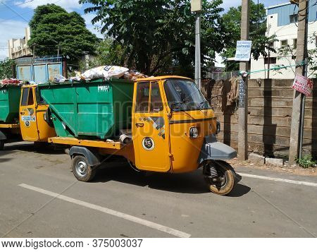 Closeup Of Garbage Collecting Green And Yellow Color Auto Parking On Roadside