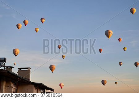 Cappadocia, Turkey - December 20, 2019: Hot Air Balloons Flying In Blue Sky With White Clouds Over H
