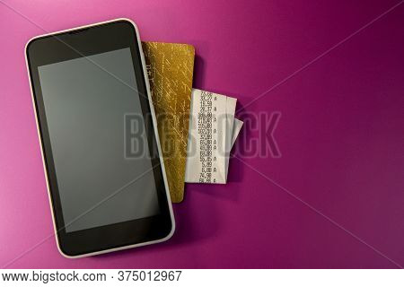 Mobile Phone Credit Card And Check Lie On A Purple Background. Web Banner. Business Concept.