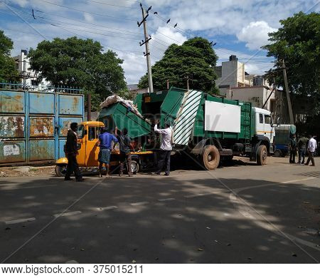 Bangalore, Karnataka/india-june 30 2020: Closeup Of Garbage Collecting Workers Working To Unload Was