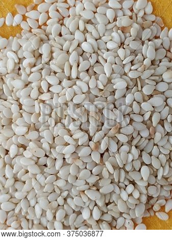Pile And Heap Of A White Sesame Or Gingili Seeds. Texture And Backdrop