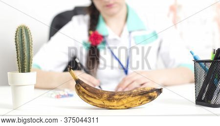 Black Banana In The Foreground In The Office Of A Doctor Of A Sex Therapist. The Concept Of The Prob