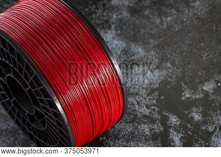 Filament For 3d Printing. Bright Thermoplastic Of Neon Red, Color. Reel Vertical View. Macro